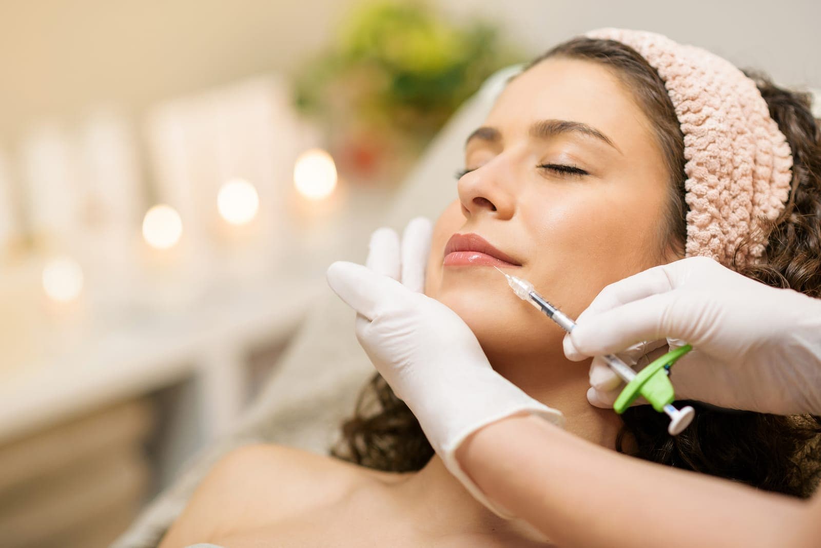 A patient receiving a hyaluronic acid dermal filler injection in a clinical aesthetic setting