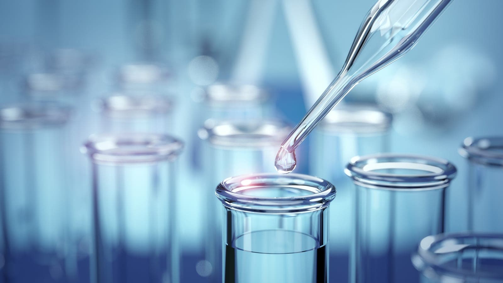 A dropper dispensing liquid into test tubes in a pharmaceutical laboratory, representing recombinant enzyme production